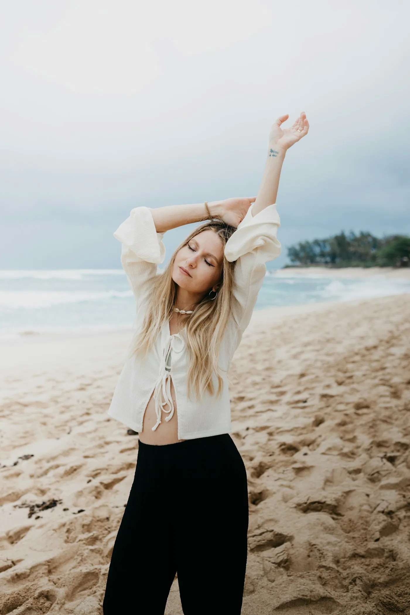 Open arms on the sand